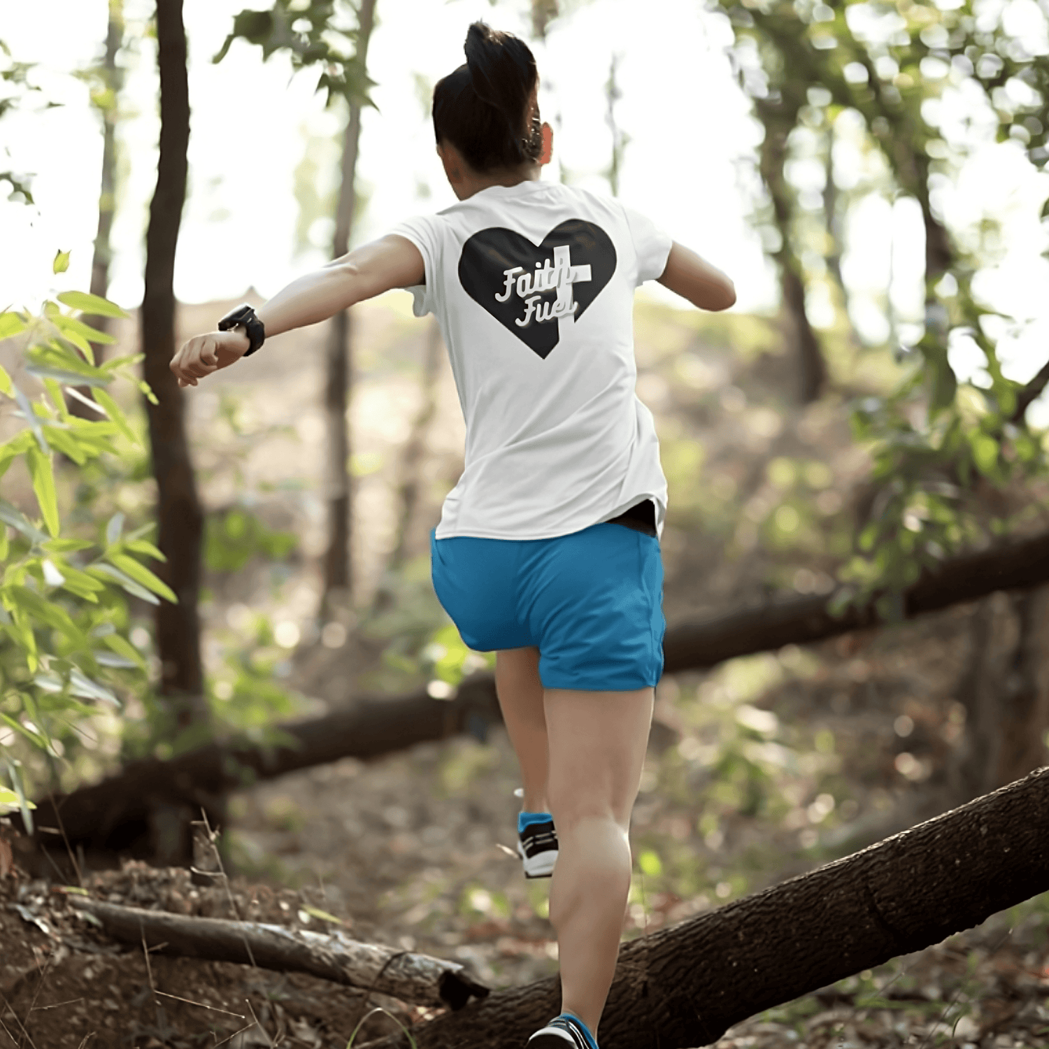 Model Wearing a Christian Fitness Shirt called Faith at My Core by Tough Nation running through the woods 