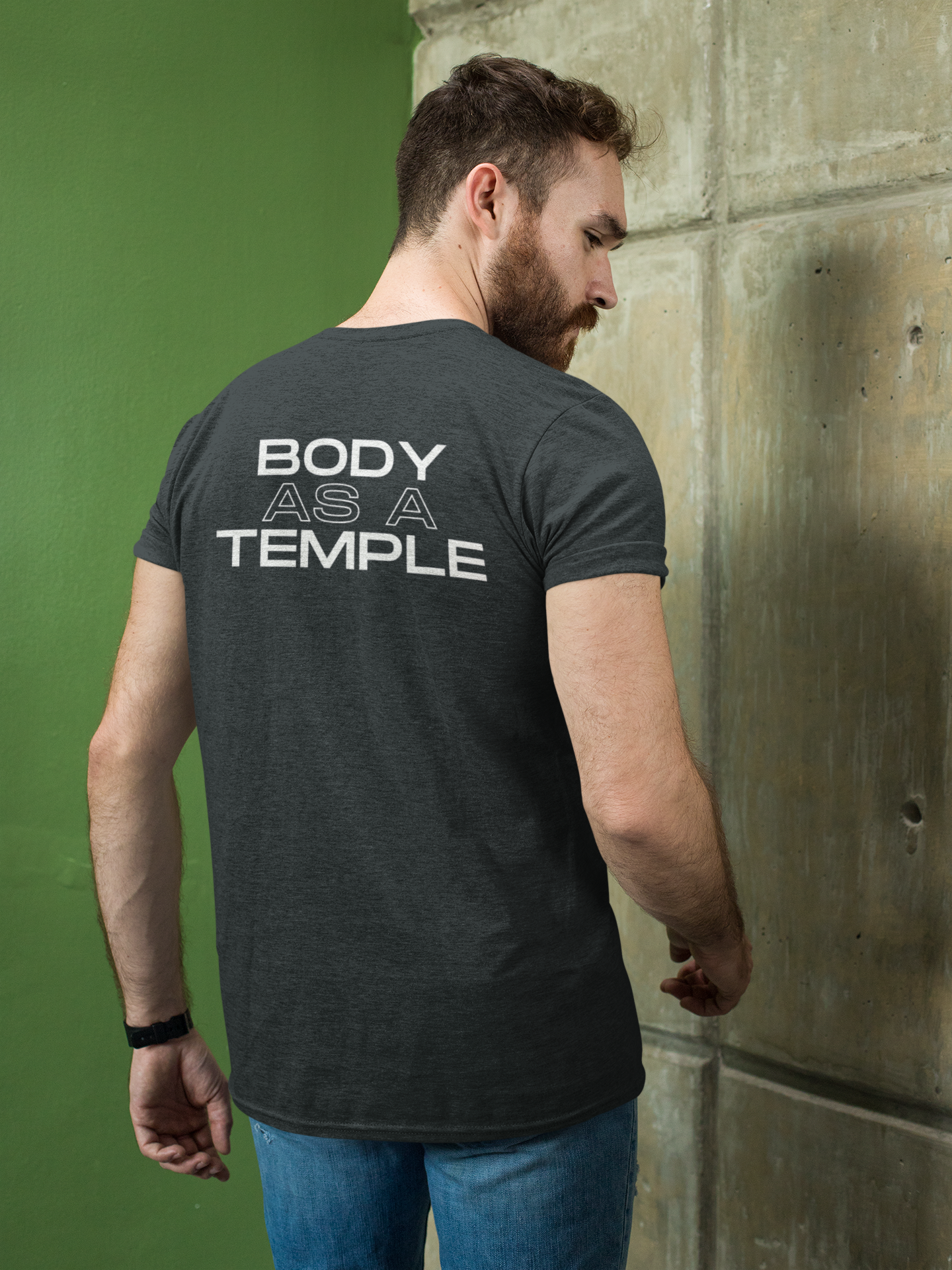 A Christian man confidently wearing a Navy shirt with the message 'Body As A Temple' on the back. His hands are in his pockets, conveying a sense of determination for Christ-centered fitness.